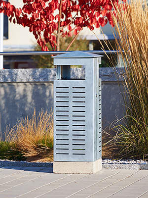 The Nora litter bin in galvanized steel in an urban environment.